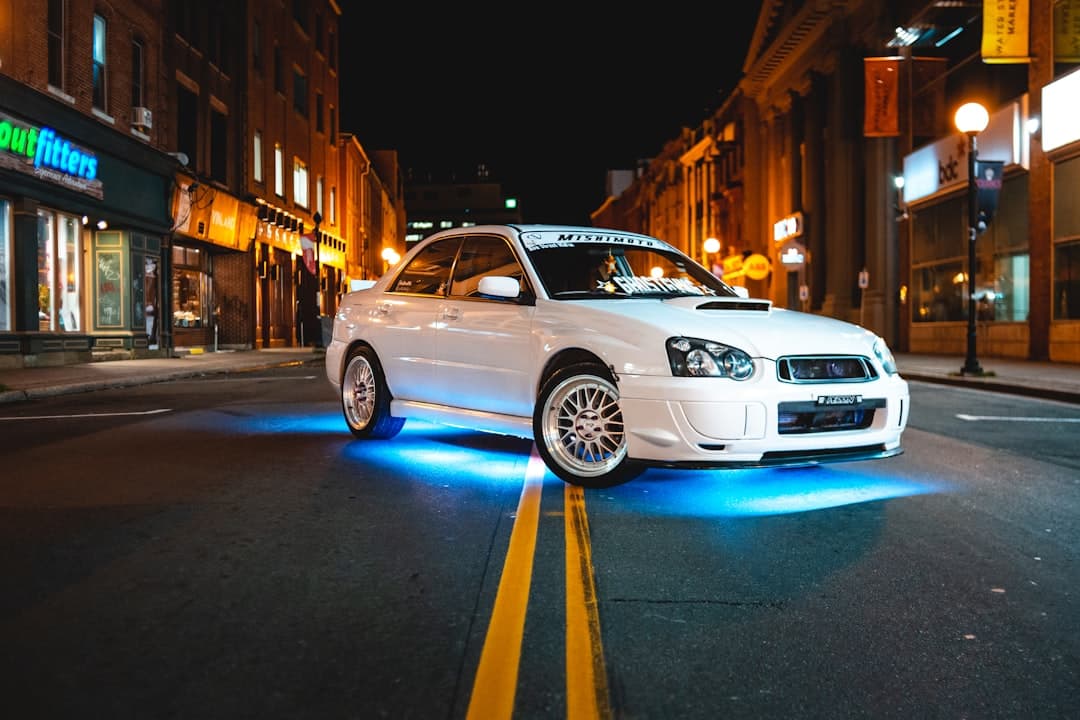 white SUbaru Impreza sedan on road